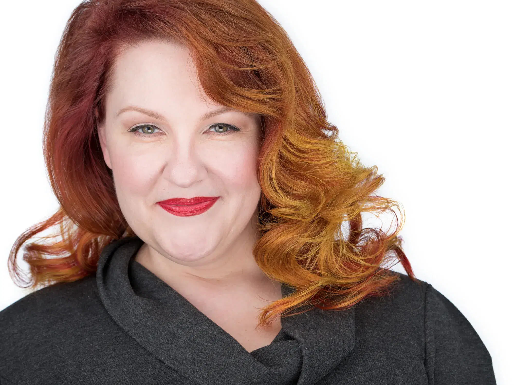 Woman with shoulder-length auburn hair and warm smile in professional actor headshot against white studio backdrop — Boston actor headshot photographer Damon Bates Photography