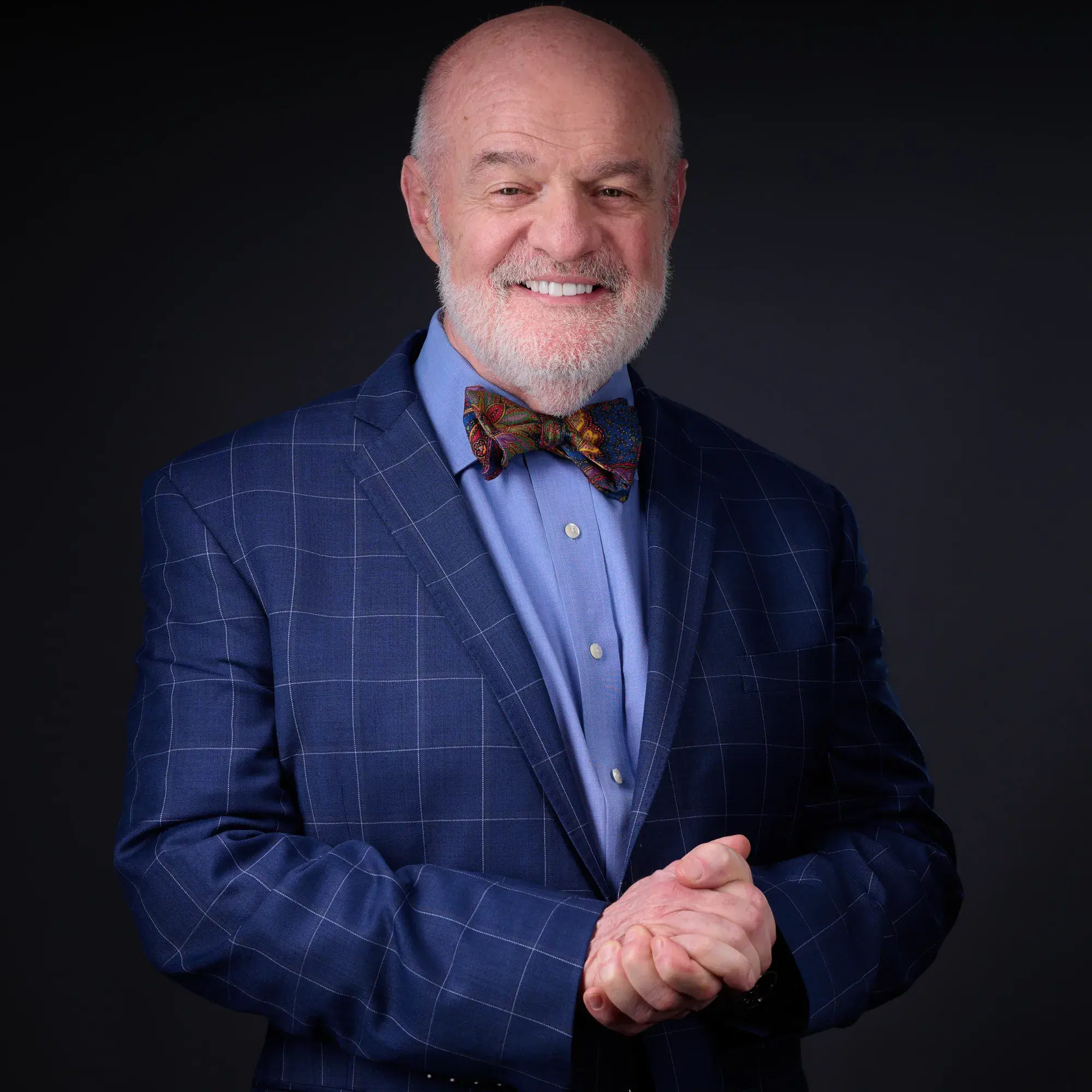 Professional business portrait of man in navy blazer and colorful bow tie in three-quarter pose — Boston business portrait photographer Damon Bates Photography