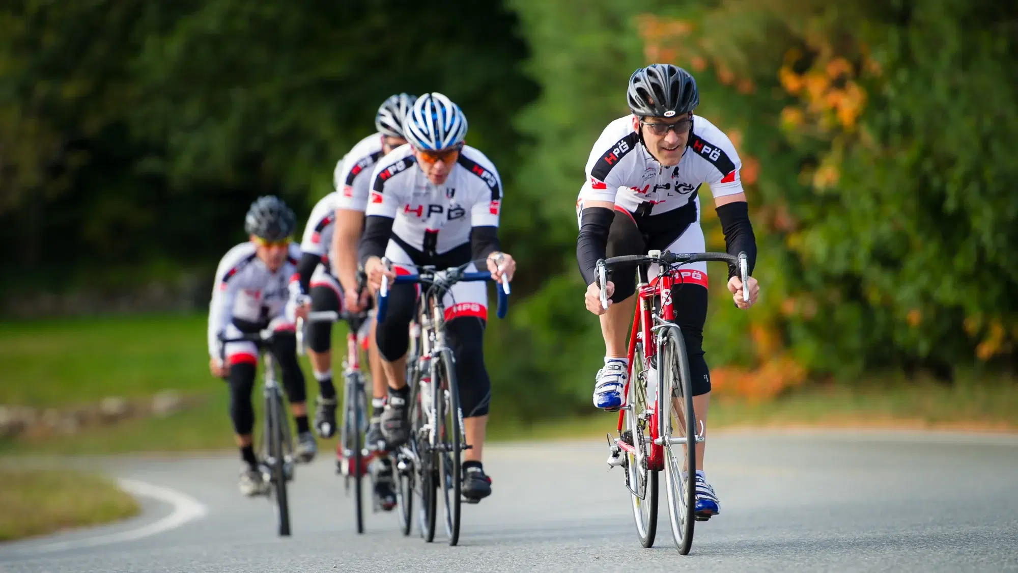 A team riding together in formation — a lesson in building a great team from Boston executive leadership coach and headshot photographer Damon Bates
